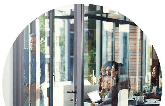 A semi-circle photograph of office workers being photographed through a glass window or door